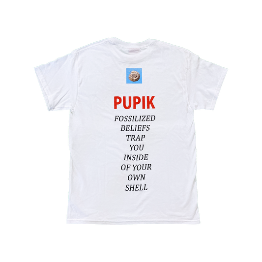 Back view of the Pupik white T-shirt featuring a small fossil graphic at the top, red Pupik text, and the phrase “Fossilized beliefs trap you inside of your own shell” printed vertically down the back.