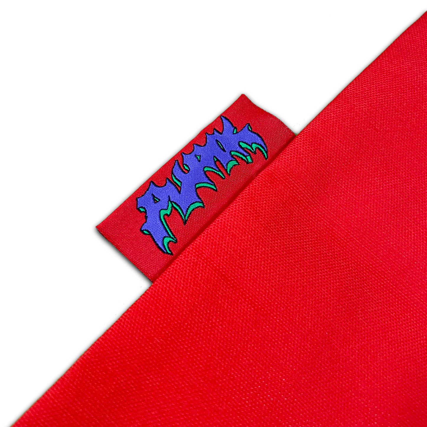 Close-up of Pupik Red Tote Bag logo tag with flame-style text