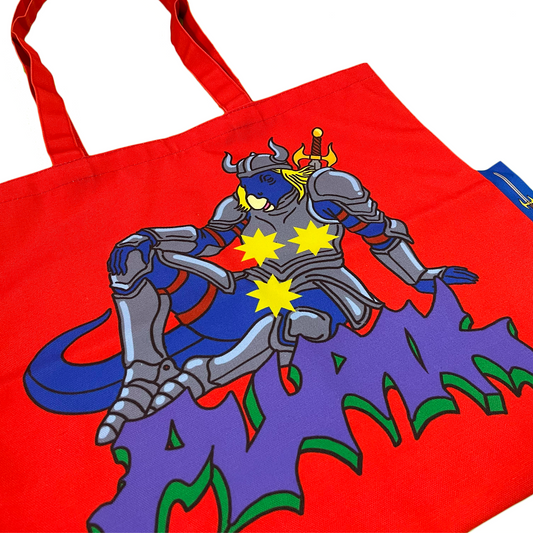 Pupik Red Tote Bag with blue knight design and side tag close up