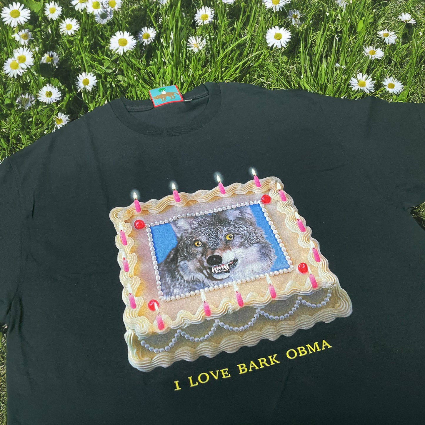 Close-up of Pupik I Love Bark Obma T-shirt featuring a wolf printed inside a birthday cake design with candles and yellow text