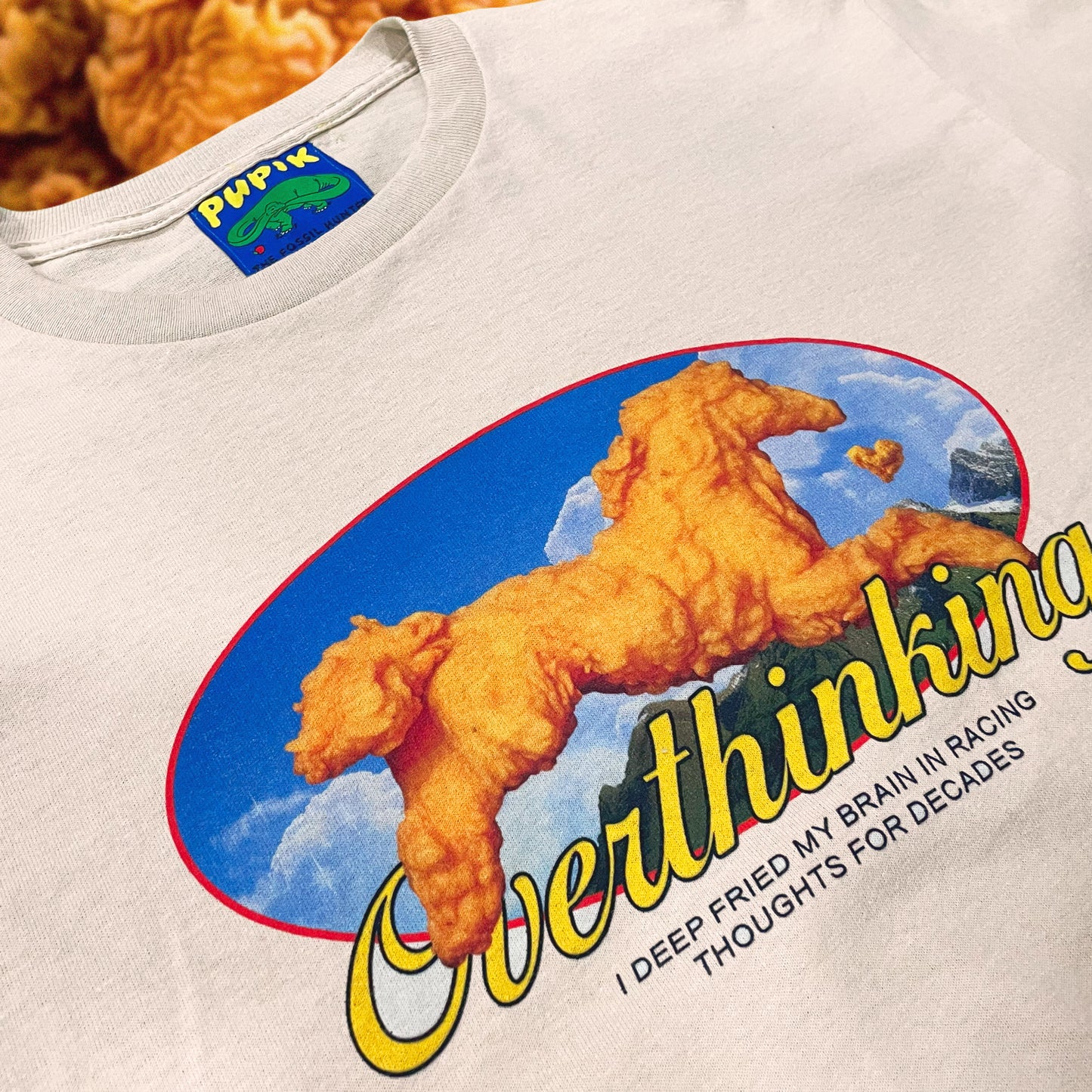 Pupik Racing Thoughts T-Shirt — front graphic in beige.