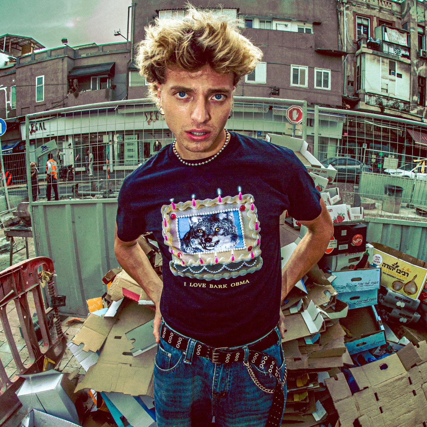 Person wearing a t-shirt with a graphic design in an urban setting