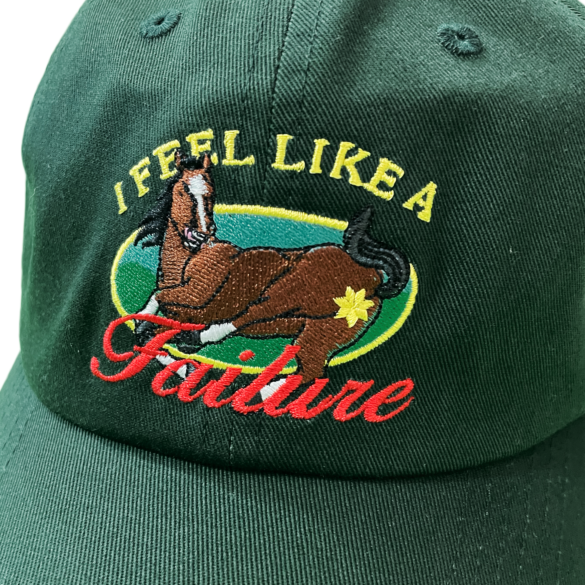Green cap with embroidered horse and text design on a plain background