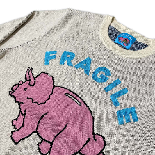Close-up of the knitted texture and stitched graphic on the Fragile sweater