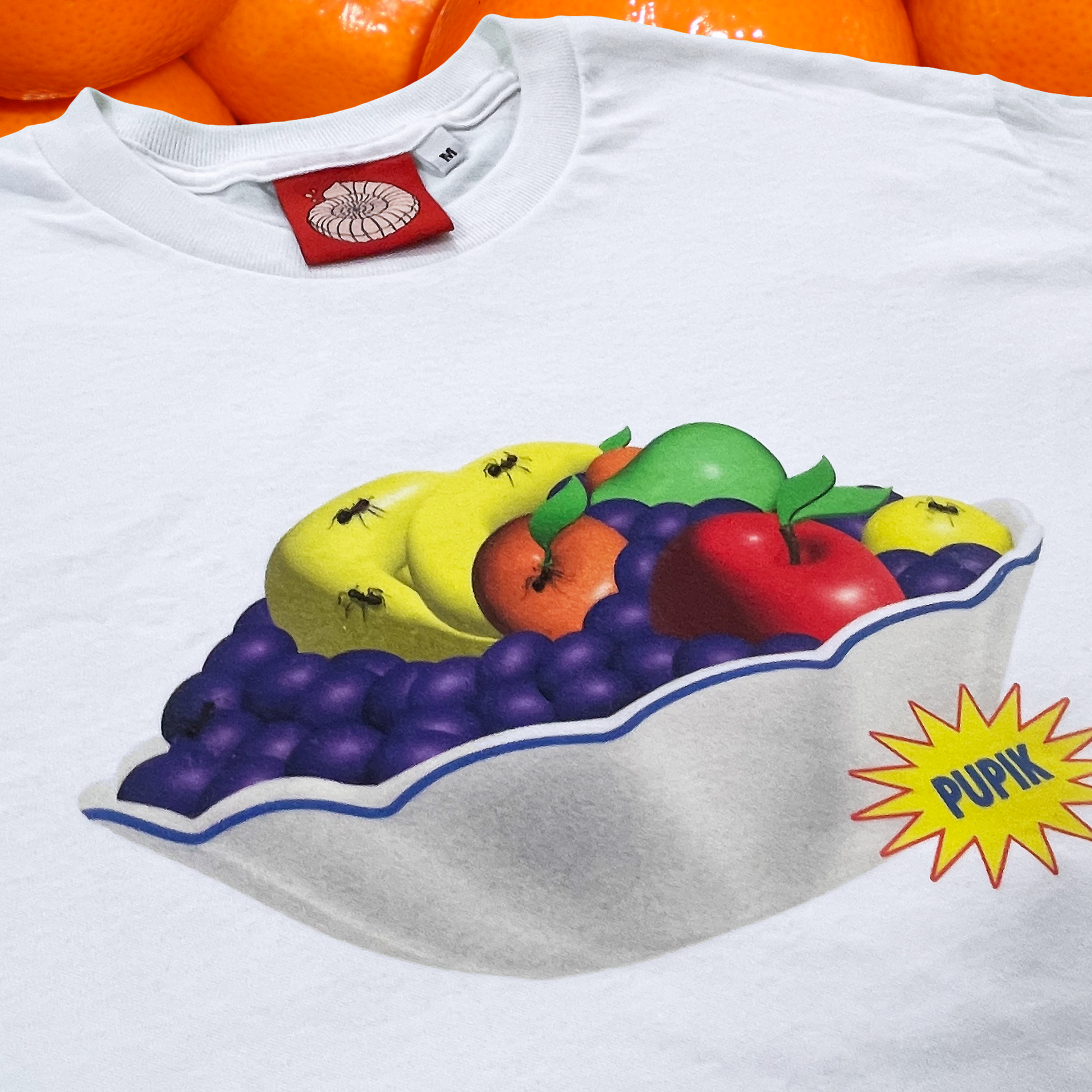 Pupik Fruit Bowl T-Shirt — white tee with fruit bowl graphic on the front.