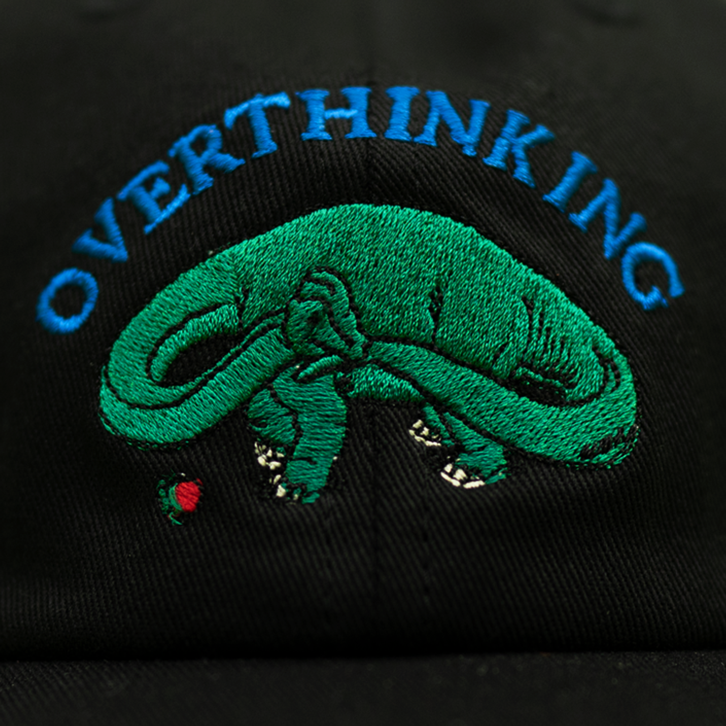 Black Pupik cap with “Overthinking” embroidery on the front and Pupik embroidery on the back.