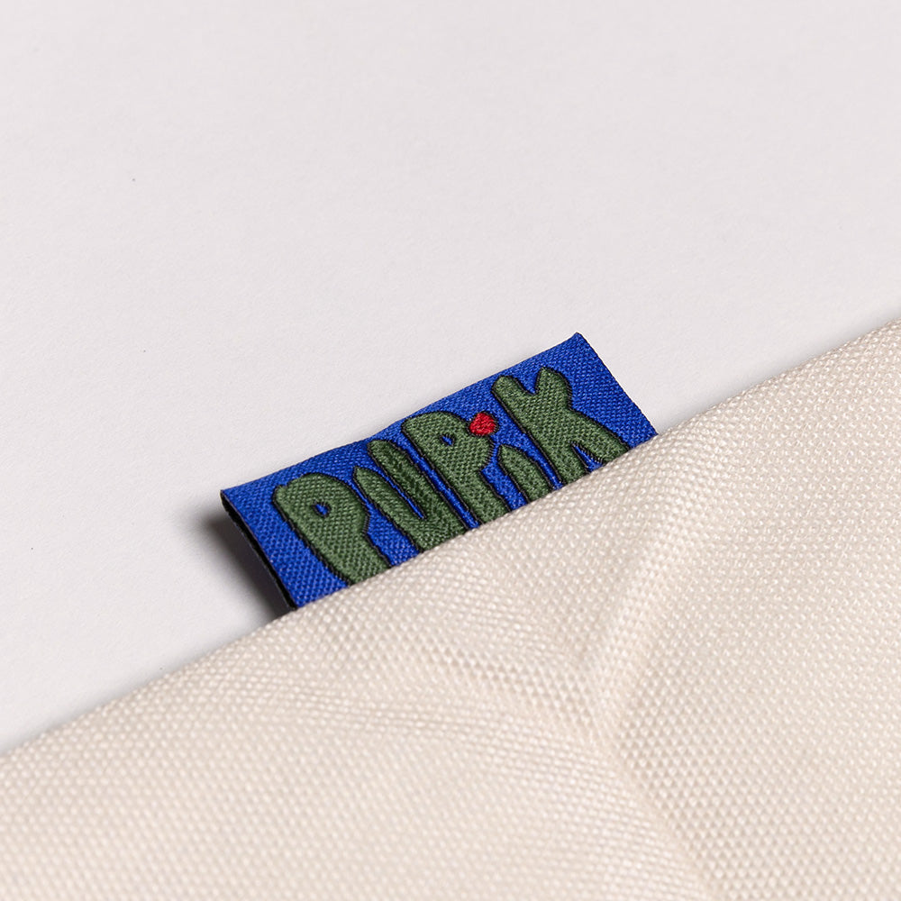 Fabric tag with 'pupik' branding on a white background