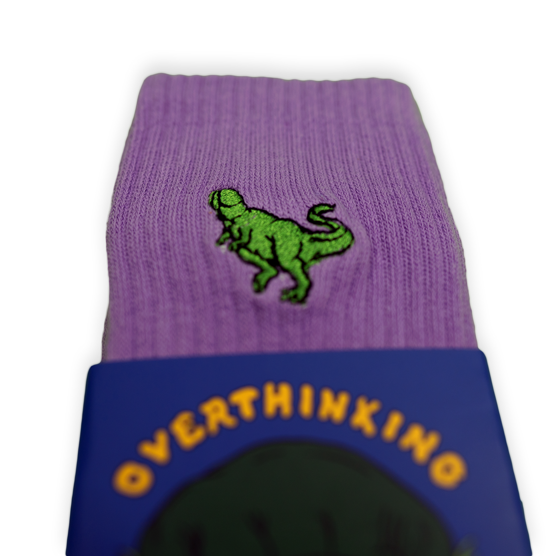Purple socks with a small green Pupik embroidery and Overthinking packaging sleeve.