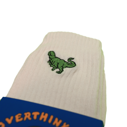 Cream socks with a small green Pupik embroidery and Overthinking packaging sleeve.