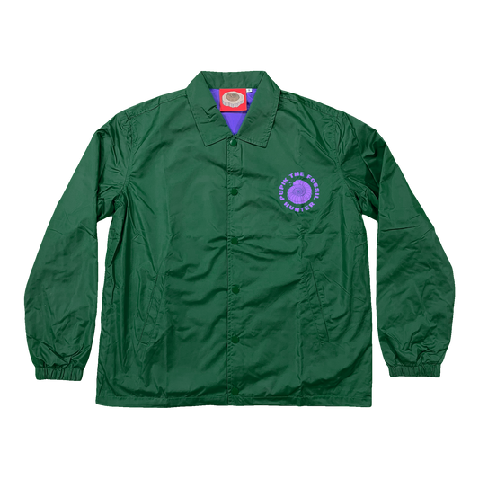 Pupik green windbreaker with a small purple Pupik graphic printed on the left chest.