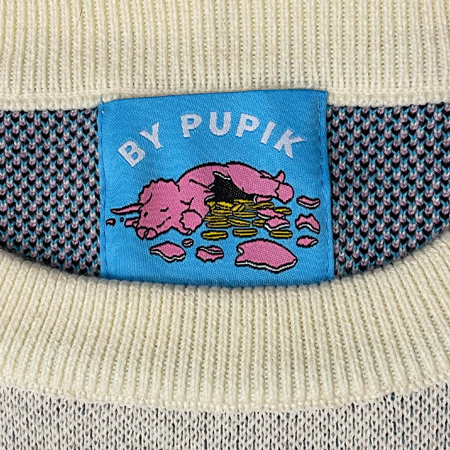 Close-up of the knitted texture and stitched graphic on the Fragile sweater